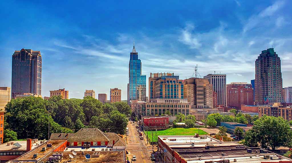 Raleigh, the capital of North Carolina, can be seen on a sunny afternoon. You can find moving labor in Raleigh when you use the Moving Help Marketplace.
