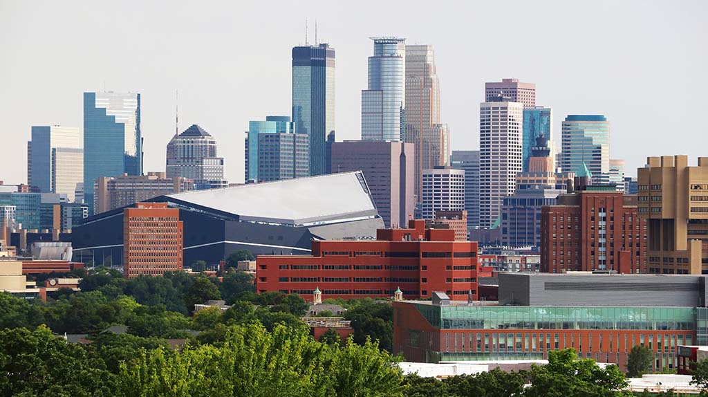 Downtown Minneapolis, Minnesota, can be seen in the distance. Moving Help has moving labor in Minneapolis who can help you with all your labor-only needs, including loading, unloading, packing, unpacking, and more.