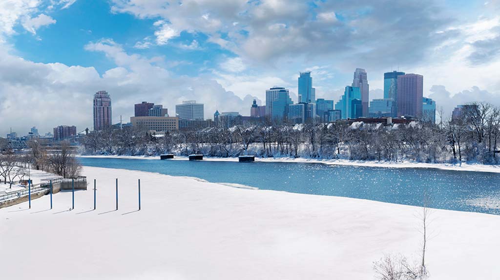 Downtown Minneapolis, Minnesota, can be seen on a cloudy, wintery day. The Moving Help Marketplace offers moving labor providers experienced in winter moves in Minneapolis, which will ensure a successful move.