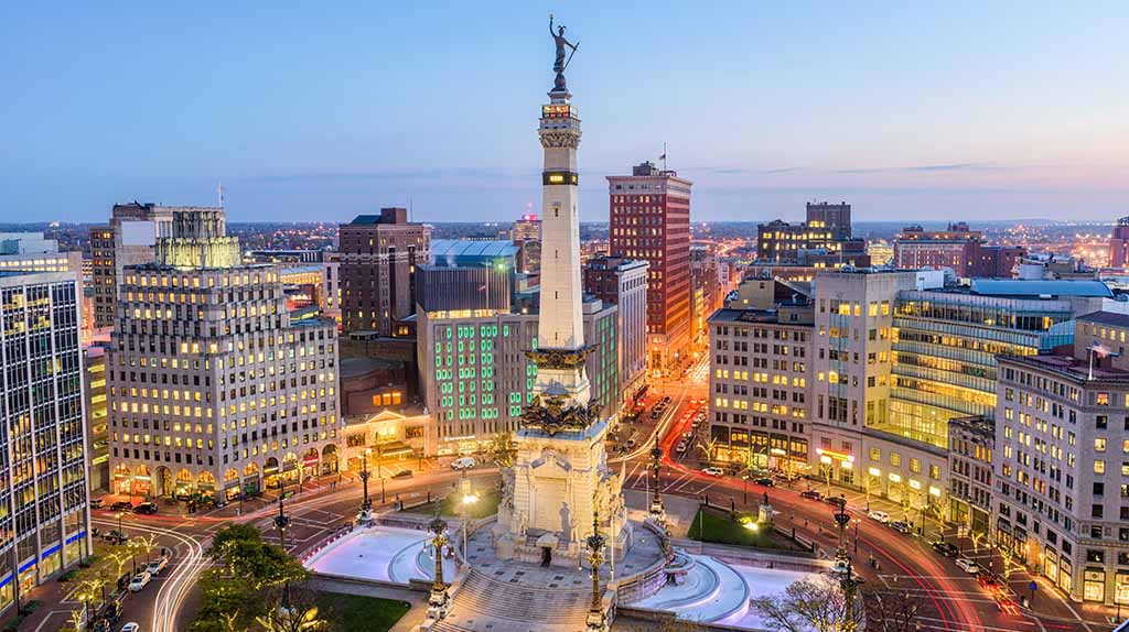 Monument Circle and the rest of downtown Indianapolis can be seen as the sun begins to set for the day.