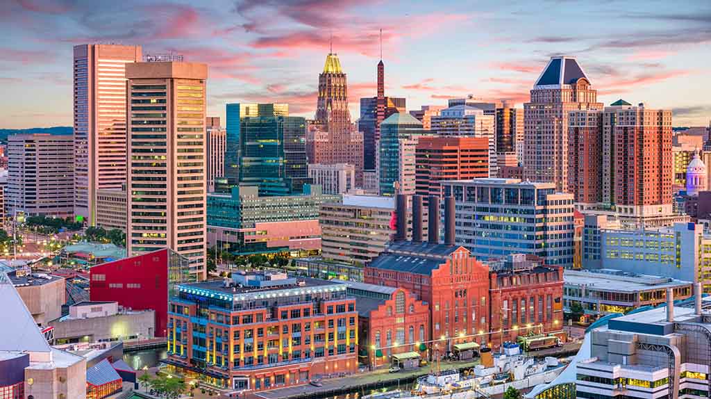 Downtown Baltimore is shown on a mostly sunny evening in an aerial shot.