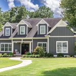 The picture shows a beautifully maintained front yard and house that’s for sale for potential buyers. Home staging includes making sure your front yard looks inviting to buyers.