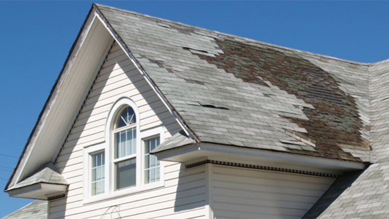 A house’s roof appears to have some roofing damage.